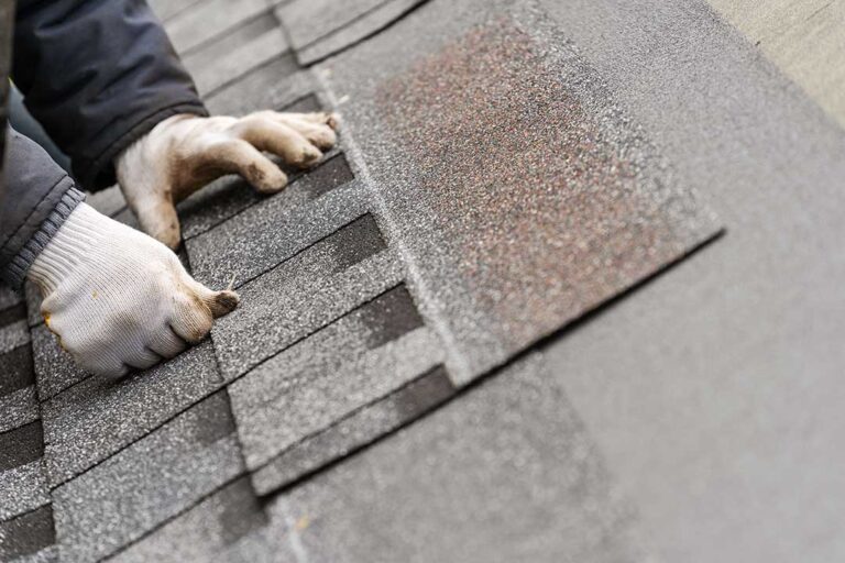 Homeowner checks roof edges and gutters from the ground before leaving for vacation.